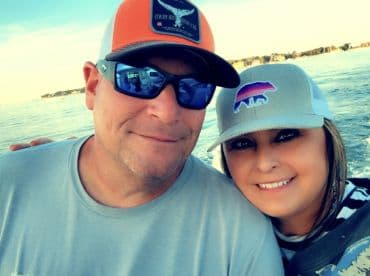 A happy couple enjoys a scenic boat ride, capturing a moment of joy on the water — perfect for romantic getaways or fun outings.