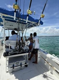 A group enjoys a fishing trip aboard a boat, showcasing camaraderie and the thrill of on-water activities in a beautiful setting.