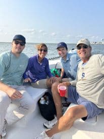 A cheerful group of friends enjoys a day on the boat, capturing the essence of fun and camaraderie on the water.