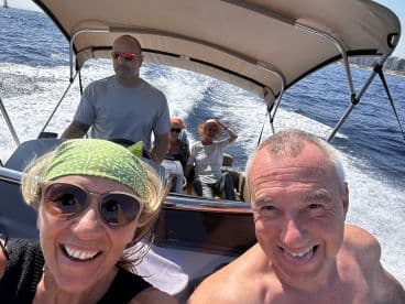 A joyful group enjoys a sunny day on the water, capturing the excitement of their boating adventure. Perfect for showcasing fun moments with friends or family.