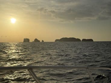 A breathtaking sunset view over distant islands, capturing the serene beauty of the coastline — perfect for sunset cruises and scenic boat trips.