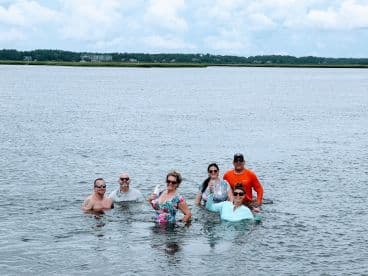 A lively group enjoys a refreshing swim in the water, showcasing the joy of summer adventures and memorable moments on the water.