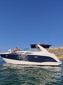 A group of friends enjoys a sunny day on a Bayliner boat, showcasing the perfect summer getaway on the water.