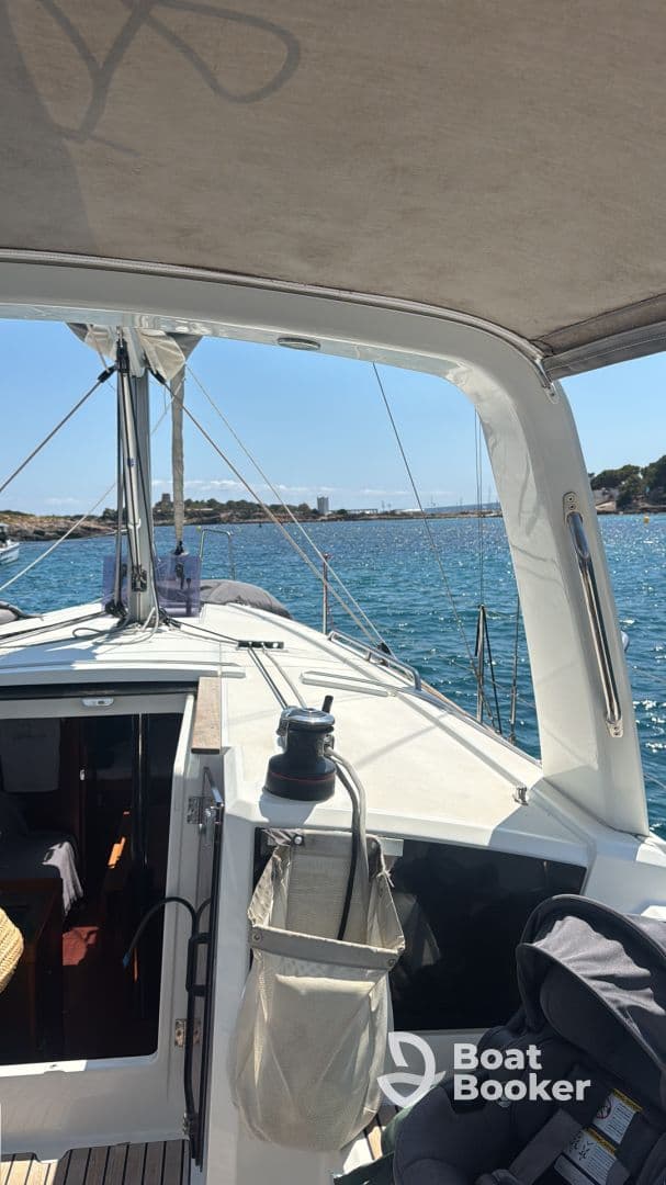 A view of the interior helm area of a sailboat, showcasing the seating and cabin space, perfect for relaxing while enjoying a day on the water.