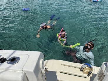 A family enjoys snorkeling in clear waters, creating unforgettable memories while exploring the underwater world.