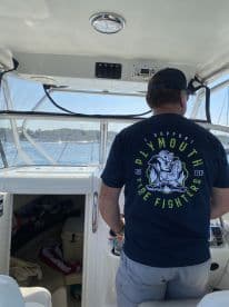 A person at the helm of a boat, showcasing the interior cabin and console area — perfect for navigating the waters in style.