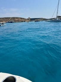 A vibrant scene showcasing a busy bay filled with boats and stunning turquoise waters, perfect for exploring the coastline and enjoying a day on the water.