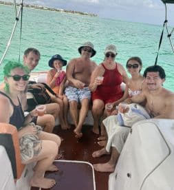 A joyful group enjoys cocktails aboard a boat, capturing the essence of a fun-filled day on the water with family and friends.