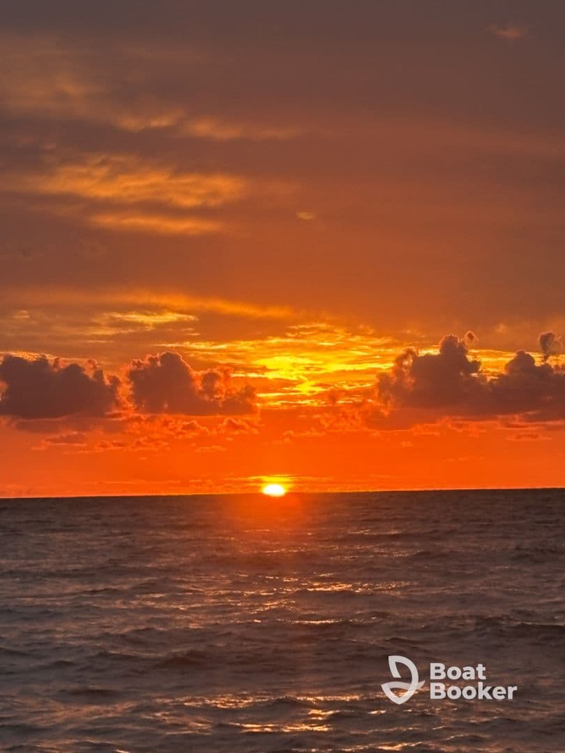 A breathtaking sunset over the ocean, showcasing vibrant hues of orange and gold — a perfect backdrop for romantic evenings or serene boat trips.