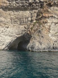 A stunning view of a rocky coastline featuring a natural cave, perfect for exploring the beautiful marine landscapes.