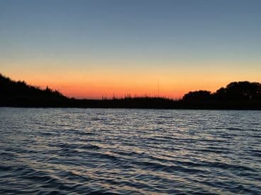 A stunning sunset over tranquil waters, capturing the serene beauty of nature — perfect for evening boat trips or romantic getaways.