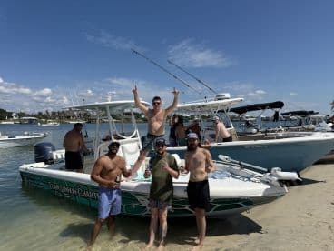 A lively group enjoys a fun day on the water, celebrating with drinks and laughter aboard their boat — perfect for summer outings and beach parties.
