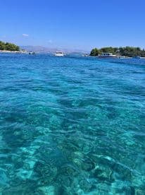 A stunning view of crystal-clear turquoise waters and a picturesque coastline, perfect for showcasing the beauty of a boating adventure.