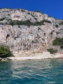 A stunning view of a rocky coastline with a secluded beach, perfect for exploring and enjoying the natural beauty of the area.
