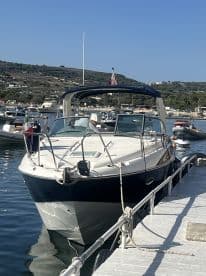 A sleek speedboat docked at the marina, showcasing its elegant design and ready for the next adventure on the water.