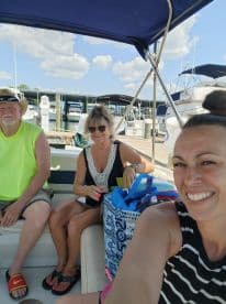 A cheerful group of friends enjoys their time aboard a boat at the marina, ready for a day of adventure on the water.