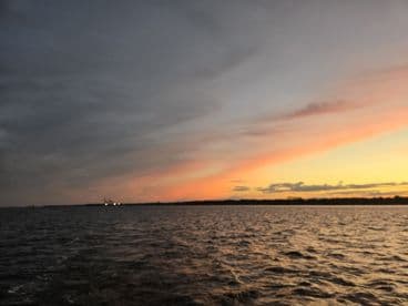 A stunning sunset over tranquil waters, showcasing the beauty of nature and the perfect backdrop for a peaceful boating experience.