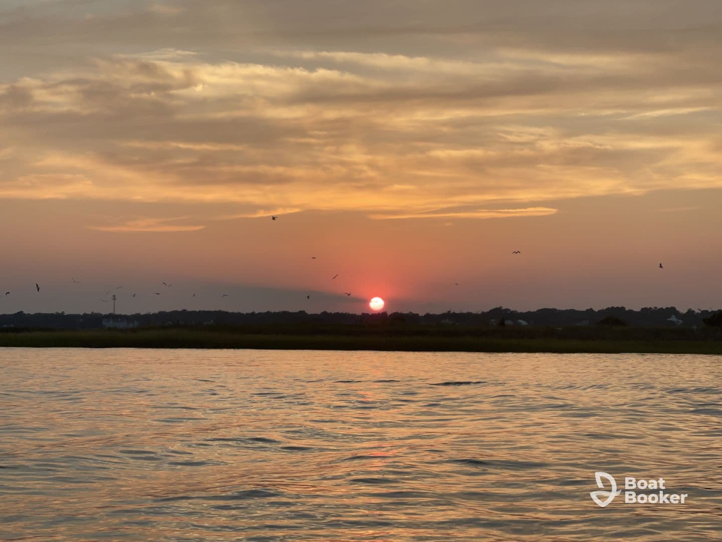 A serene sunset view over calm waters, capturing the beauty of nature — perfect for peaceful boating experiences.