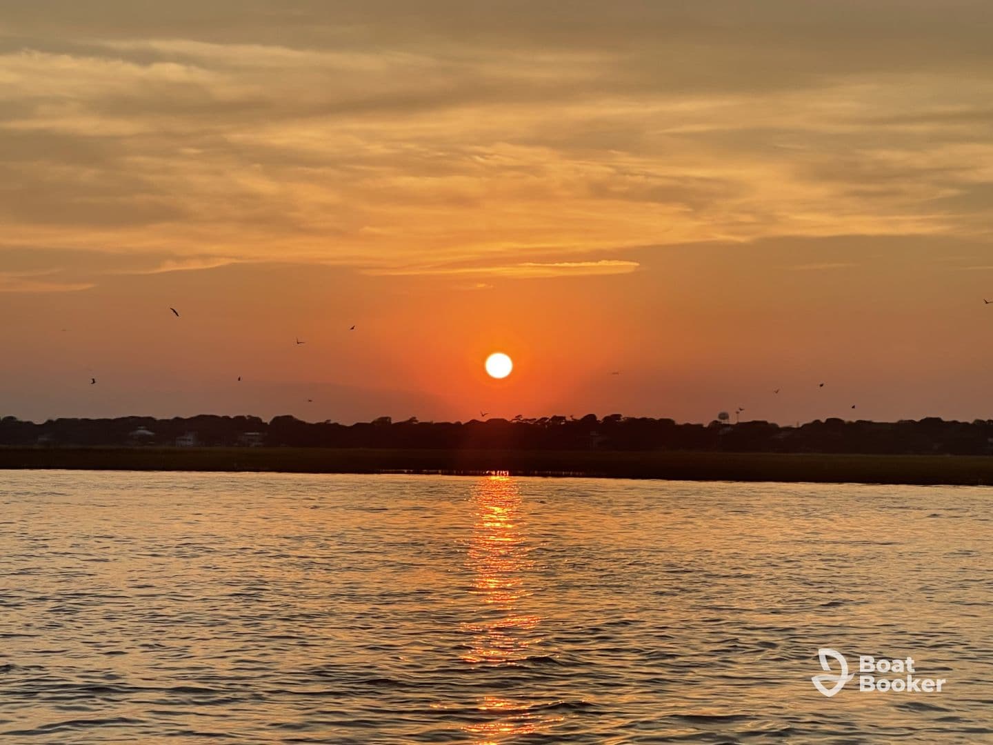 A stunning sunset reflects on the water, creating a serene atmosphere perfect for evening boat rides or peaceful moments on the water.