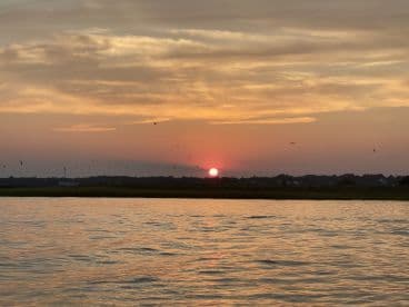 A serene sunset view over calm waters, capturing the beauty of nature — perfect for peaceful boating experiences.