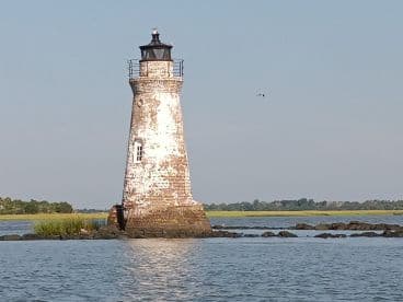 A picturesque view of a historic lighthouse standing tall against a serene coastal backdrop, perfect for capturing the beauty of maritime landscapes.