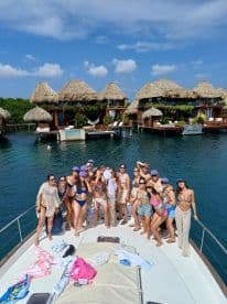 A lively group of friends celebrates aboard a boat, enjoying the sun and water — perfect for a fun day out or a special occasion.