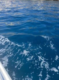 An abstract view of water with ripples and foam, lacking clear subject matter or identifiable features.