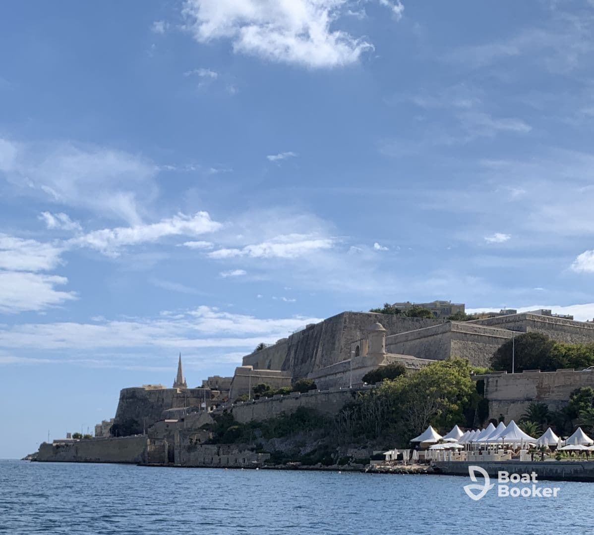 A stunning view of a historic coastal landmark with a beautiful sky, perfect for capturing the essence of a scenic boat trip.