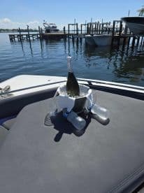 A stylish setup featuring a bottle of champagne in an ice bucket, ready for a relaxing day on the water. Perfect for celebrations or leisurely outings.