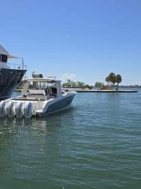 A sleek speedboat docked in calm waters, showcasing its modern design and powerful engines — perfect for thrilling water adventures.