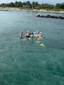 A group of friends enjoys a fun day swimming and snorkeling in clear waters, perfect for creating unforgettable memories on a boating adventure.