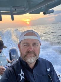 A selfie taken during a sunset boat ride, capturing the joy of a day on the water with friends. Perfect for showcasing memorable boating experiences.