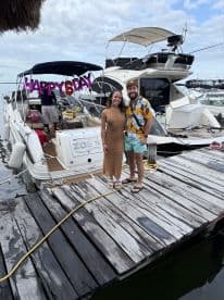 A couple celebrates a birthday on a boat, showcasing a festive atmosphere with decorations and smiles — perfect for memorable moments on the water.