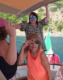 A lively group of women enjoying their time on a boat, showcasing the fun and camaraderie of a day out on the water.