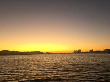A blurry sunset view over the water, capturing the transition of colors in the sky, perfect for serene evening reflections.