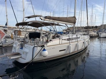 A sleek Odyssey 439 yacht docked in a marina, showcasing its elegant design and readiness for sailing adventures.