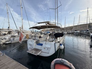A beautiful yacht docked in a marina, showcasing its sleek design and tranquil surroundings — perfect for sailing enthusiasts and boat lovers.