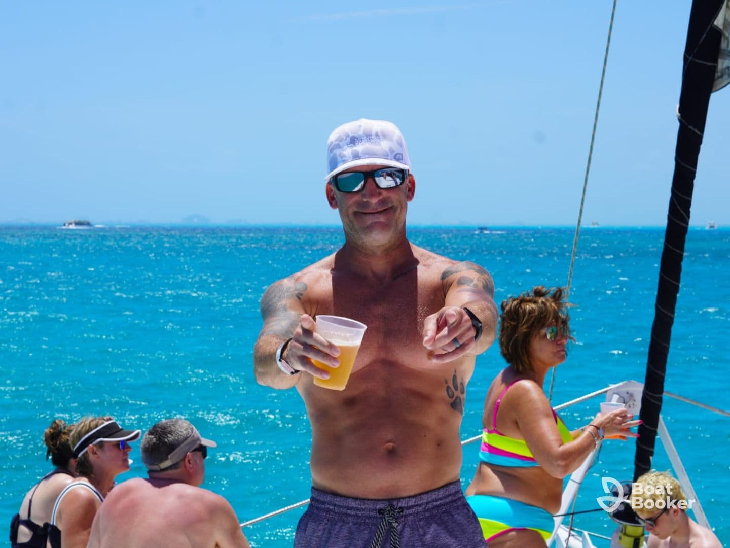 A lively scene aboard a yacht with guests enjoying drinks and the sun, capturing the essence of a fun day on the water.