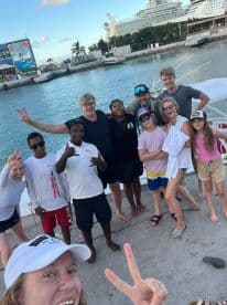 A joyful group poses for a selfie at the dock, celebrating their cruise adventure together — a perfect moment of camaraderie and fun.