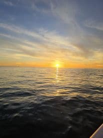 A stunning sunset over calm waters, capturing the serene beauty of a boating experience — perfect for romantic evenings or peaceful reflections on the water.