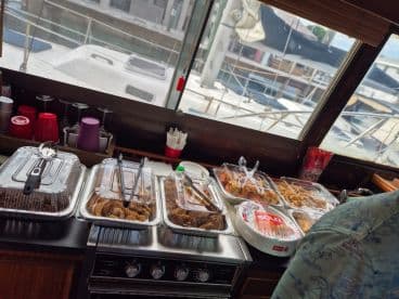 A beautifully arranged spread of food in the boat's dining area, perfect for catering events or group gatherings on the water.