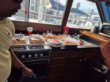 A selection of delicious catered food displayed in the galley of a boat, perfect for onboard dining experiences during a cruise.