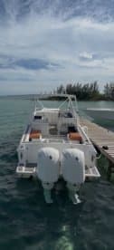 A sleek speedboat docked in clear waters, showcasing its modern design and inviting atmosphere for a day on the water.