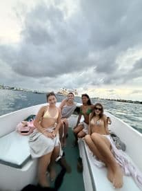 A group of friends enjoys a boat ride, capturing the essence of fun and camaraderie on the water. Perfect for memorable outings and celebrations.