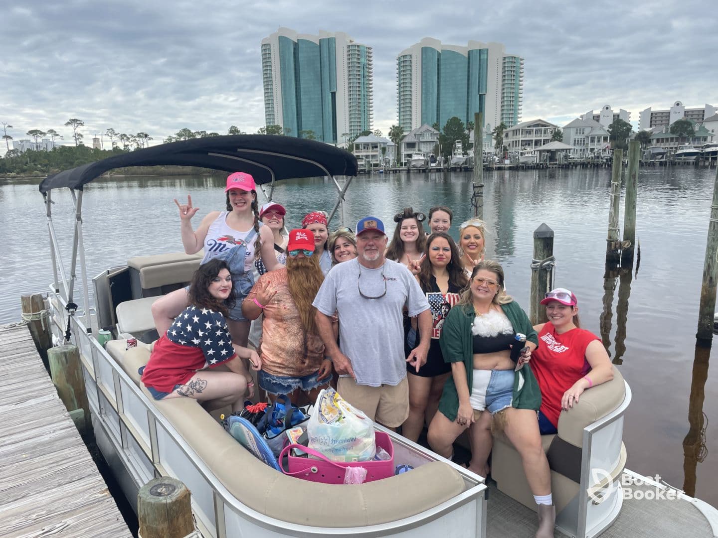 A lively group of friends poses on a pontoon boat, ready for a fun day on the water — perfect for celebrations and memorable outings.