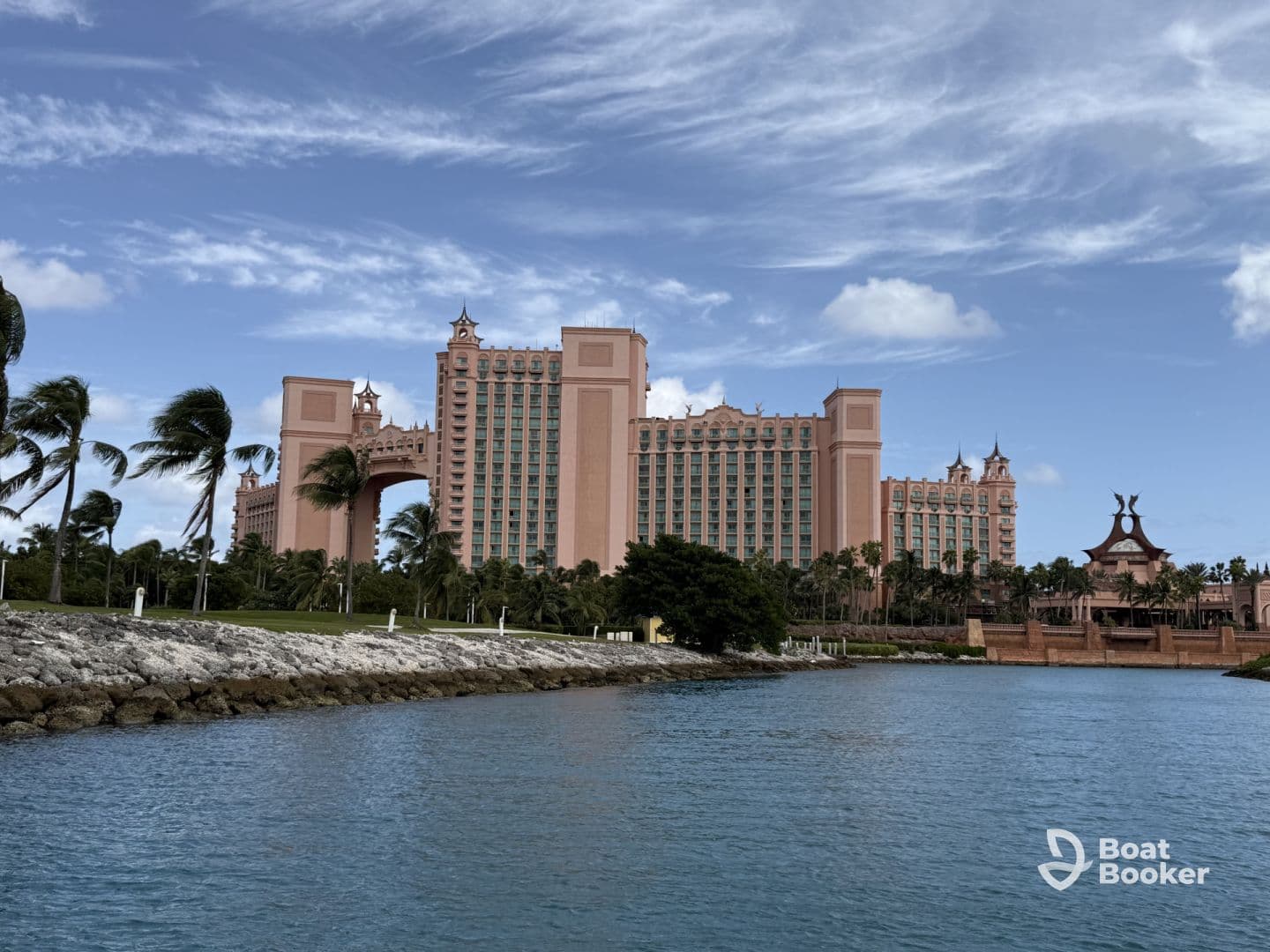 A stunning view of the iconic Atlantis Resort in the Bahamas, showcasing its impressive architecture against a backdrop of clear blue skies and tranquil waters.