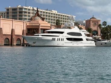 A stunning yacht named 'Skyfall' docked at a picturesque marina, showcasing luxury and elegance against a vibrant backdrop.