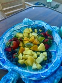 A vibrant assortment of fresh fruit served on a decorative platter, perfect for enjoying healthy snacks while on a boat trip.