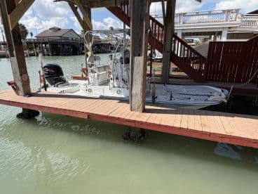 A center console boat docked at a marina, showcasing its sleek design and ready for a day on the water.