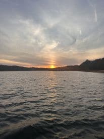 A serene sunset over calm waters, capturing the beauty of nature — perfect for peaceful evenings on the water.